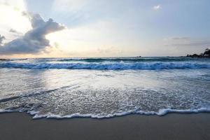 Amazing sandy tropical beach with silhouette of the beach tropical - sunrise or sunset sea dramatic sky photo