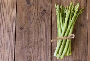 Asparagus on wooden background - Fresh green asparagus photo