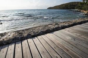 Terrace view sea with empty wooden table top on the beach landscape nature with sunrise - wooden board balcony view seascape idyllic seashore photo