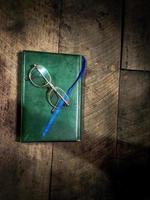 Old glasses on a book photo