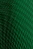 Green textured background with light effect dark abstract pattern. photo