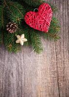 Christmas tree branches with heart decoration photo