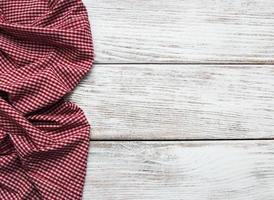 Checkered napkin on a wooden background photo