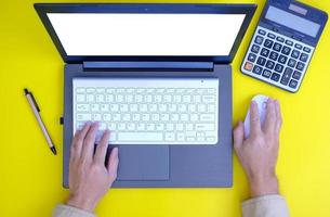 keyboard computer, smartphone with a blank screen, a notebook, are shown on a modern office desk table. Flat lay, top view with copy space photo