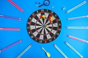 Dart board and a desk. Workspace with a target and a successful business growth concept, as well as a dart board with a target. photo