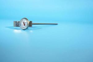 Kitchen thermometer on blue background. Isolate. Lifestyle. photo