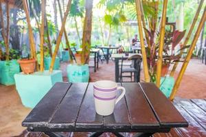 Coffee on brown wooden table on tropical Holbox island Mexico. photo