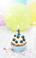 Cupcake with a numeral one candle photo