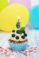 Cupcake with a numeral six candle photo