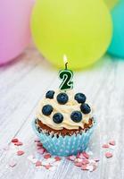 Cupcake with a numeral two candle photo