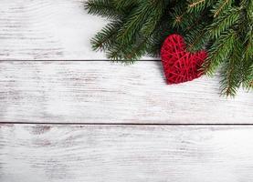Christmas tree branches with heart decoration photo
