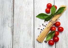 spaghetti, basil and tomatoes photo