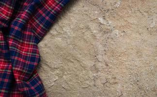 Checkered napkin on a stone background photo