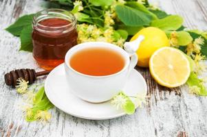 cup of herbal tea with linden flowers photo