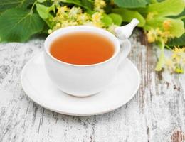 cup of herbal tea with linden flowers photo