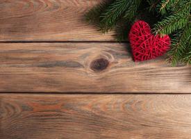 Christmas tree branches with heart decoration photo