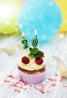 Cupcake with a numeral twenty candle photo