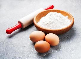 Baking ingredients - flour, eggs and pin photo