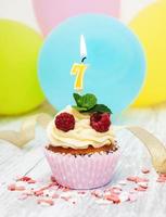 Cupcake with a numeral seven candle photo