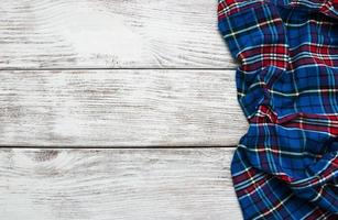 Checkered napkin on a wooden background photo