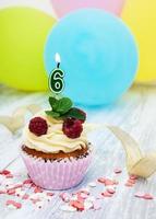 Cupcake with a numeral six candle photo