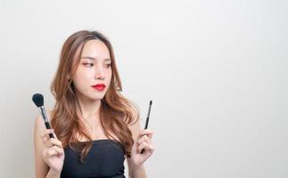 portrait beautiful woman with makeup brush photo