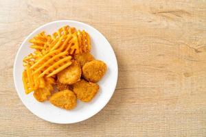 fried chicken nuggets with fried potatoes photo