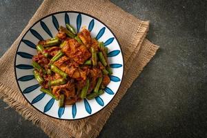 Stir fried pork with red curry paste photo