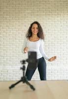 Latin woman created her dancing video by smartphone camera. To share video to social media application. photo