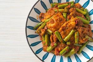 Stir fried pork with red curry paste photo