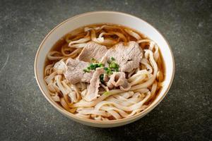 homemade udon noodles with pork in soy or shoyu soup photo