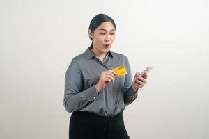 Asian woman using smartphone with hand holding credit card photo