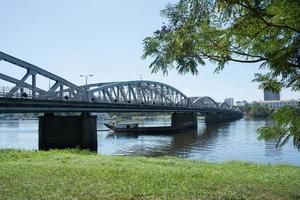 Magnificent iron bridge over the river at Hue, Vietnam. A boat under the bridge, No people. photo