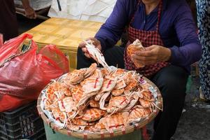 Unrecognizble person selecting crabs in a city market. Hanoi, Vietnam photo