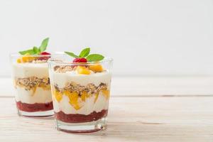 homemade mango and raspberry with yogurt and granola photo