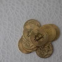 Pile of bright coins with white background. Crypto currency. photo