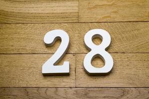 Figure twenty-eight on a wooden, parquet floor. photo