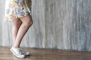 Smooth female legs on a grey background photo