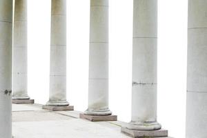 White columns on white isolated background. Historical building. photo