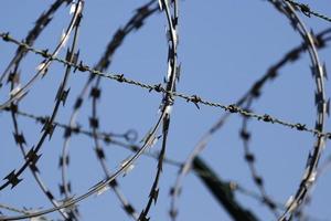 Barbed wire border fence and defense. photo