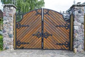 Wooden gate with wrought iron elements. photo
