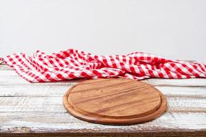 Top view wrinkled red tablecloth and plank on wooden table, mock up photo