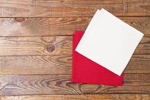 white and red napkin on wooden table top view,copy space,empty photo