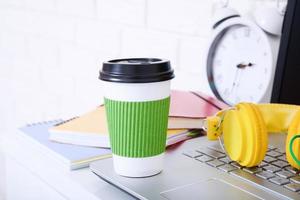 Cup of coffee on the workplace in office. Copy space and selective focus photo