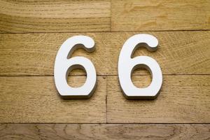 The numbers sixty-six on a wooden parquet floor. photo