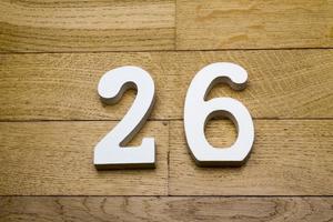 Figure twenty-six on a wooden, parquet floor. photo