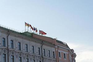 Different flags over the building in St. Petersburg. photo