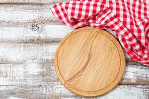 cutting desk and red checkered wrinkled tablecloth on table, holiday concept photo