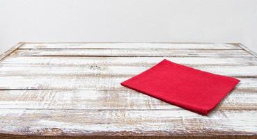 red paper napkin on wooden table with copy space - Vintage Filter, copy space photo