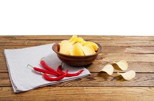 potato chips on empty wooden table isolated on white background copy space photo